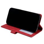 Red folio phone case holding a black smartphone propped up in landscape orientation in a stand mode.