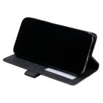 Black smartphone in a black folio case propped up as a stand on a white background