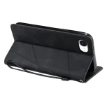 Black leather folio phone case with built-in stand and wrist strap, shown propped up for hands-free viewing (back view)