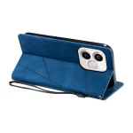 Blue leather flip phone case with diagonal stitching, lying open to reveal a dual-camera cutout on a white plate and wrist strap visible.