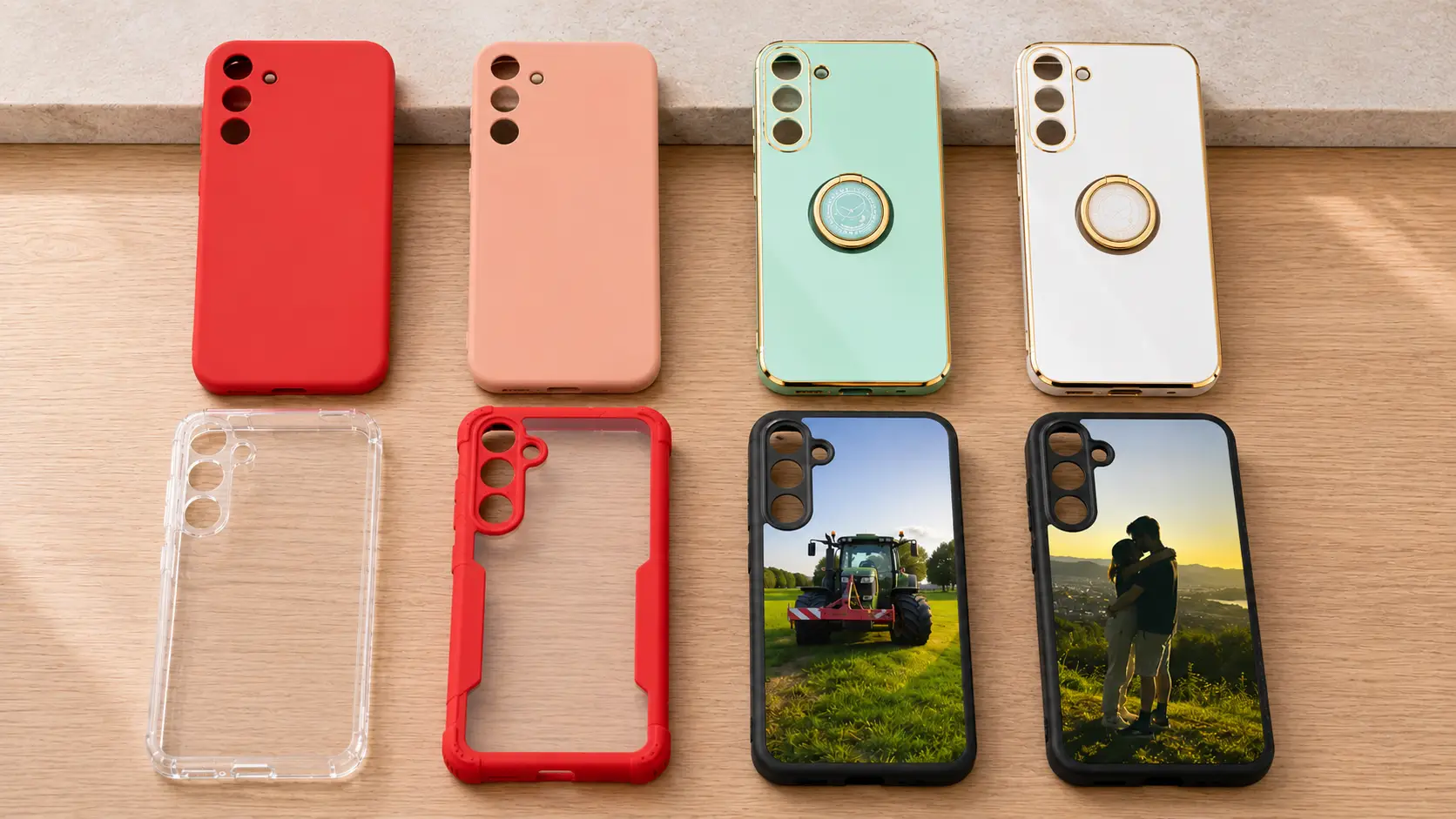 Collection of colorful smartphone cases and clear protective shells laid out on a wooden surface, with two phones showing farm and couple photos on their screens.