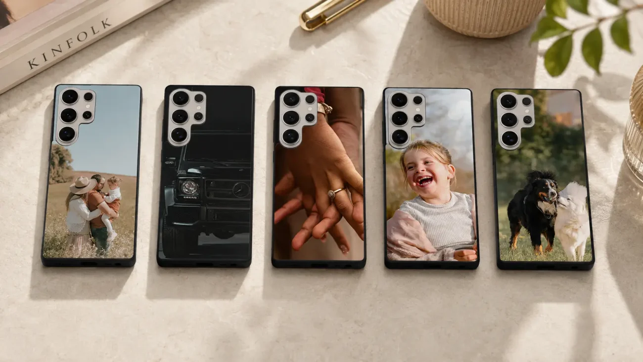Five smartphones in a row on a table, each with a personalized photo case (family with baby, a car, rings, a laughing girl, two dogs).