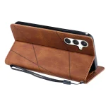 Brown leather folio phone case with three-camera module and attached wrist strap, shown from the back.